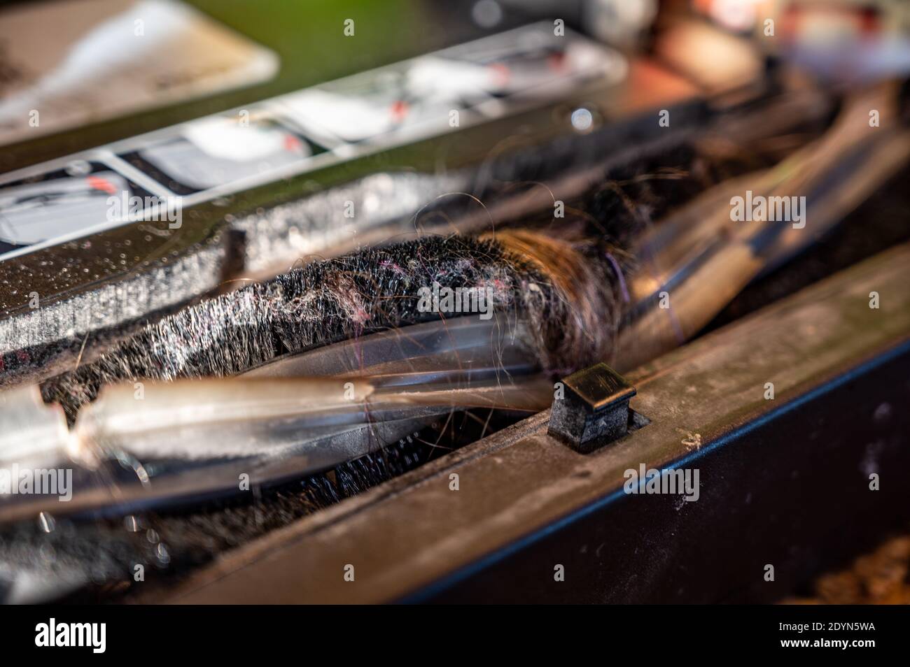Vacuum plugged from picking up long hair until the rollers stop working Stock Photo Alamy