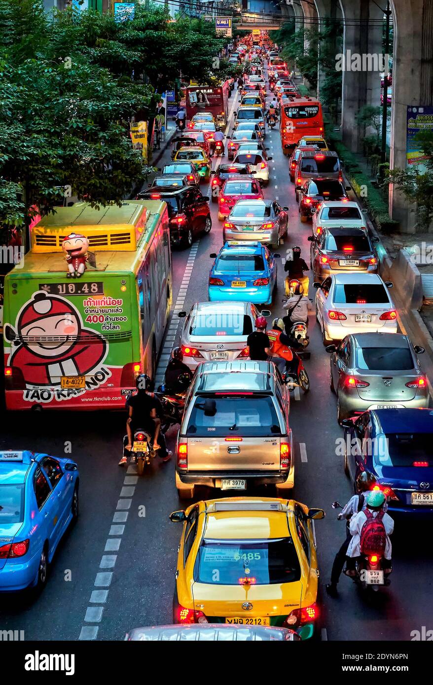 Colorful cars, taxis and motorcycles during evening rush hour at Sukhumvid Road in downtown Bangkok City, Asia Stock Photo