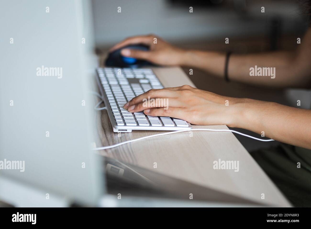 hands grasping keyboard and mouse Stock Photo
