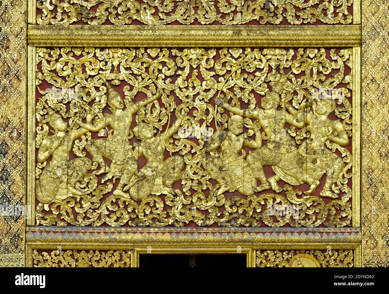 Gilded teak wood panels with rich floral carvings, Royal Funerary Carriage house, Temple Wat Xieng Thong, Luang Prabang, Laos Stock Photo