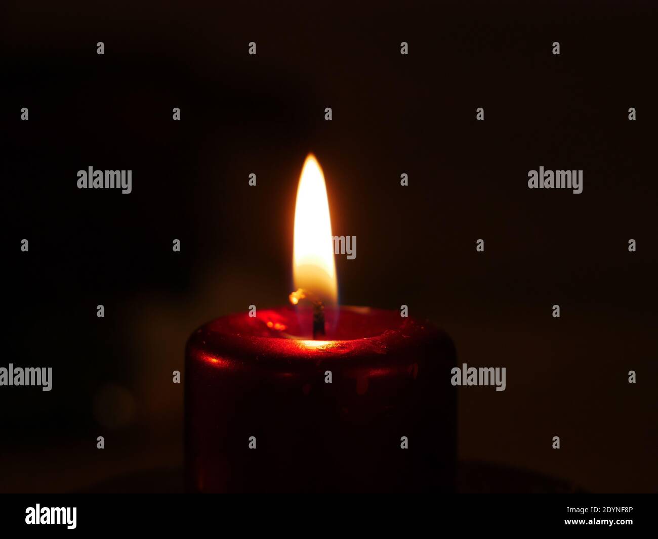 Close-up on a lit candle to make a prayer Stock Photo