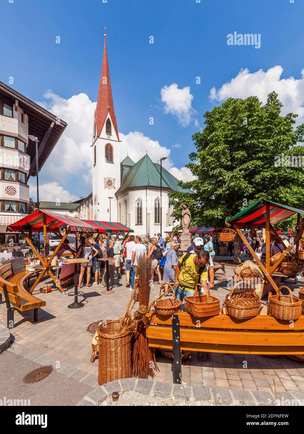 Weekly market on the village square in front of the parish church St. Oswald, pilgrimage church, Seefeld in Tyrol, Tyrol, Austria Stock Photo