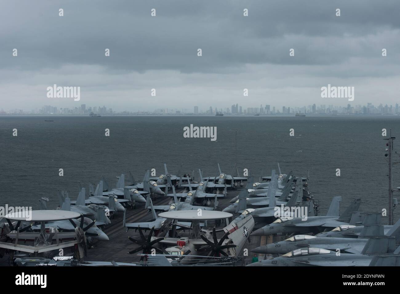 190807-N-KP021-0004 MANILA, Philippines (August 9, 2019) The aircraft carrier USS Ronald Reagan (CVN 76) anchors outside Manila, Philippines. Ronald Reagan is forward-deployed to the U.S. 7th Fleet area of operations in support of security and stability in the Indo-Pacific region. Stock Photo