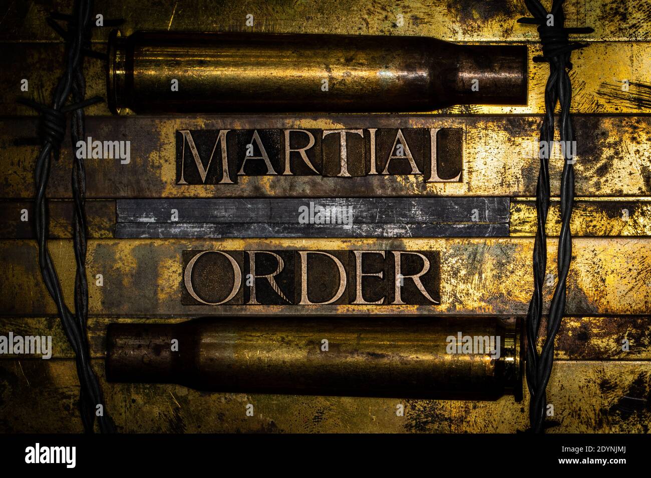 Martial Order text with 50 caliber BMG bullet casings on textured