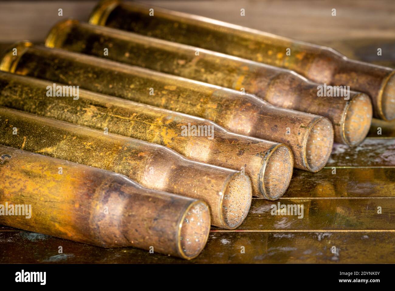 Close up of multiple 50 caliber BMG copper empty shell casings on grunge background Stock Photo