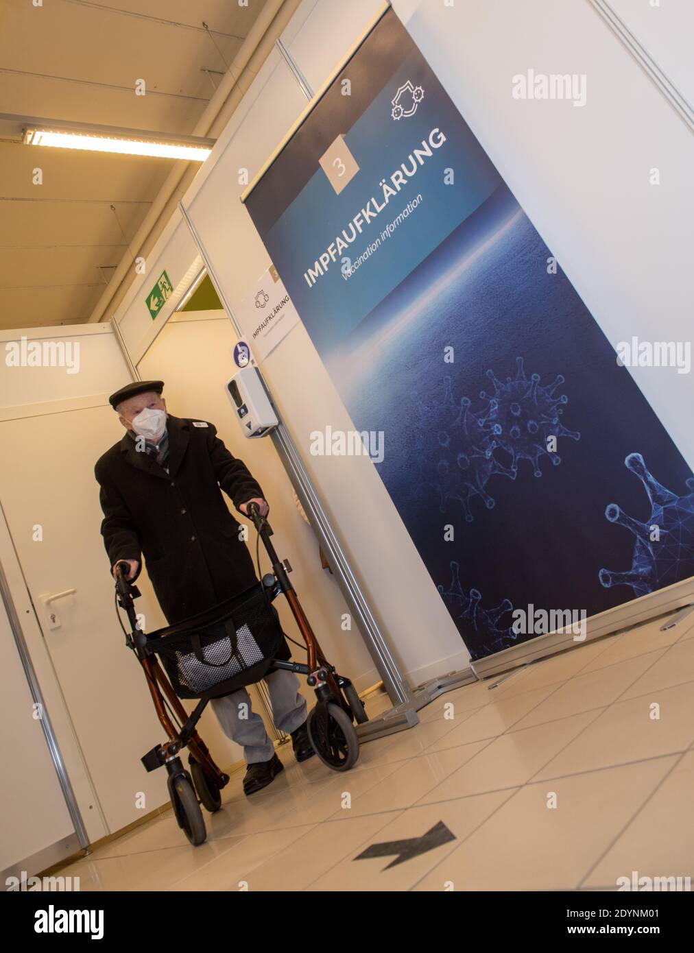 27 December 2020, Bavaria, Weißenhorn: 99-year-old Erwin Knoll walks with a walker to vaccination education at the vaccination center. Corona vaccinations with the Biontech/Pfizer vaccine started in Germany on Sunday. Photo: Stefan Puchner/dpa Stock Photo