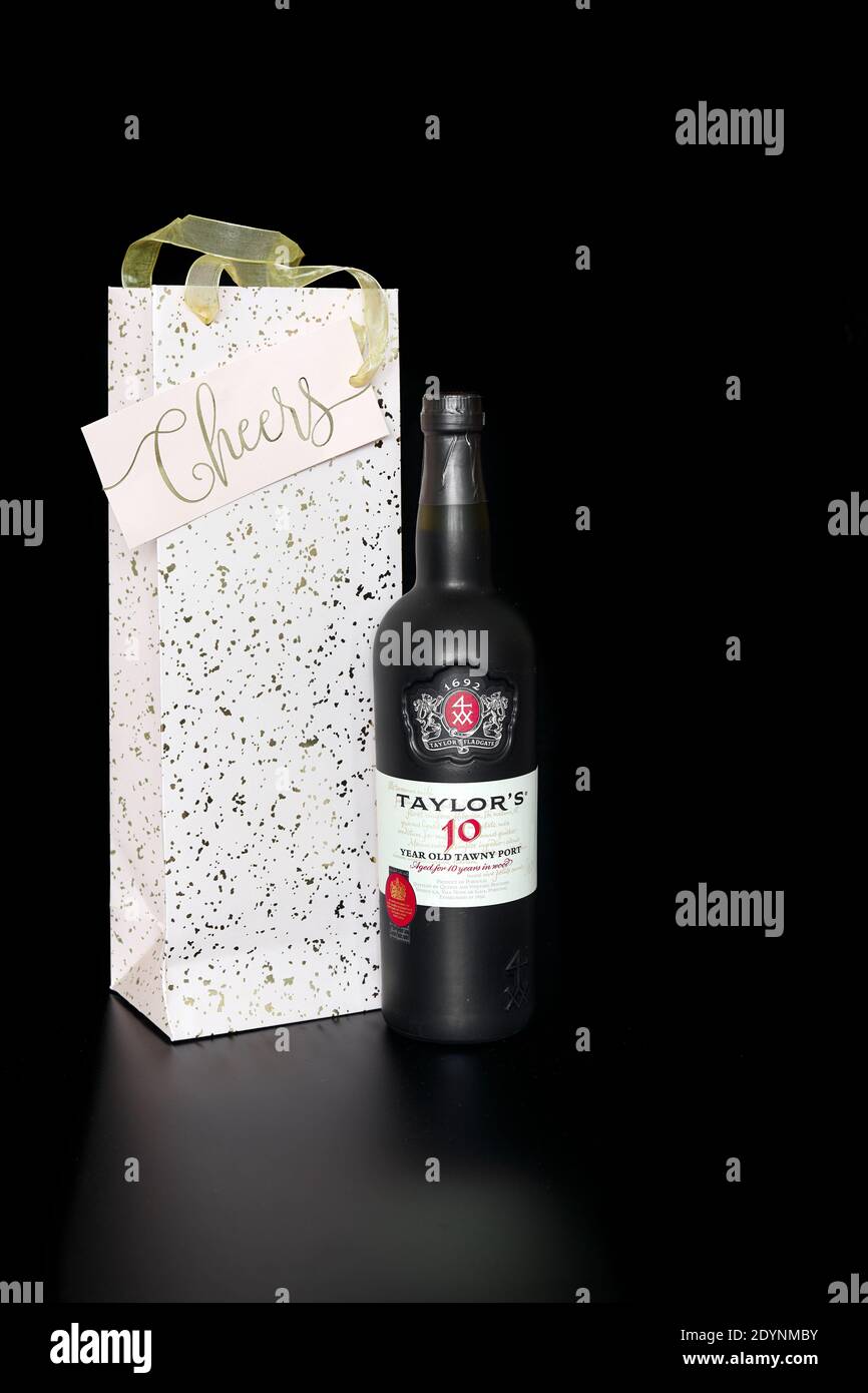 A bottle of 10 years old Taylor's tawny port and its christmas presentation bag. Stock Photo