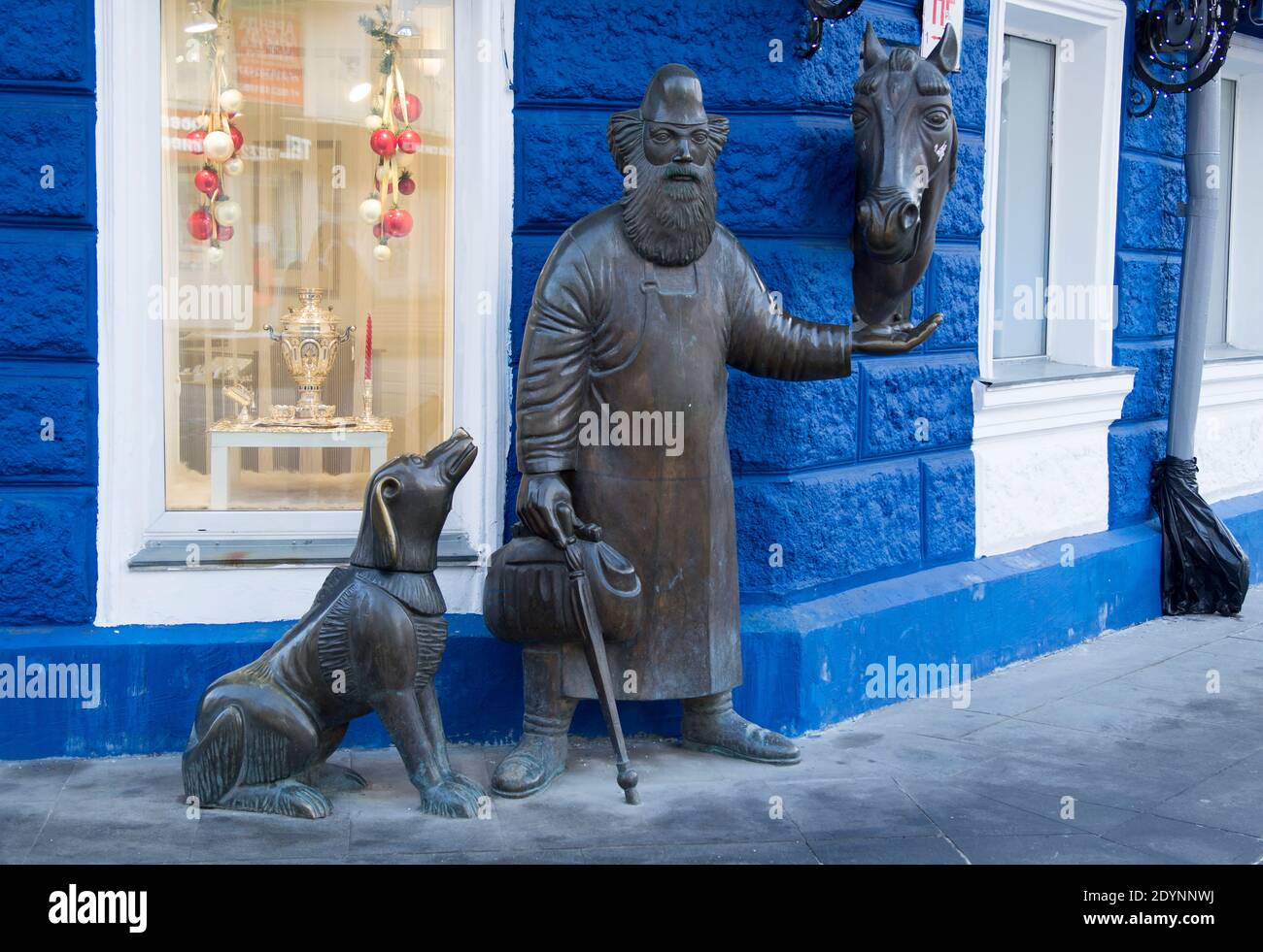YEKATERINBURG, RUSSIA -  Sculpture 'Friends' on the pedestrian street Weiner. Sculpture consists of figures of dog, the blacksmith- Stock Photo