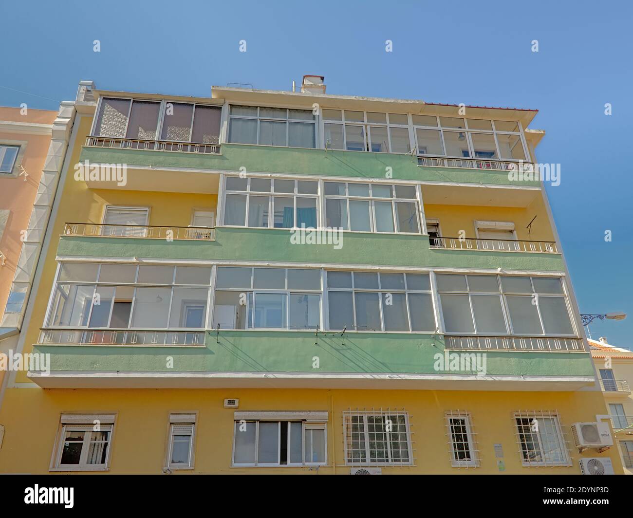 Facade of a typical apartment building in pastel colors in Lisbon ...
