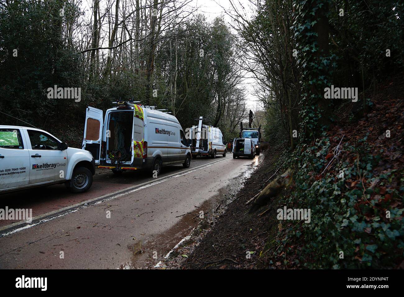 Hastings, East Sussex, UK. 27 Dec, 2020. UK Weather: The A21 from Hastings to Sedlescombe is blocked off by the police as storm Bella has blown down trees along the route. Trees have taken Power line down, according workmen they have several hours left to clear the road. Photo Credit: Paul Lawrenson/Alamy Live News Stock Photo