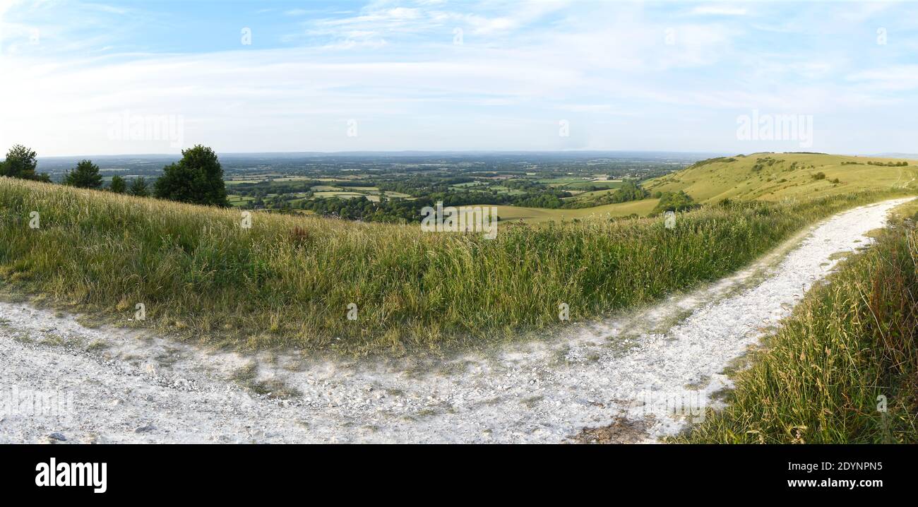 Panoramic view looking North from Ditchling Beacon, with the chalky South Downs Way trail path in the foreground. Stock Photo