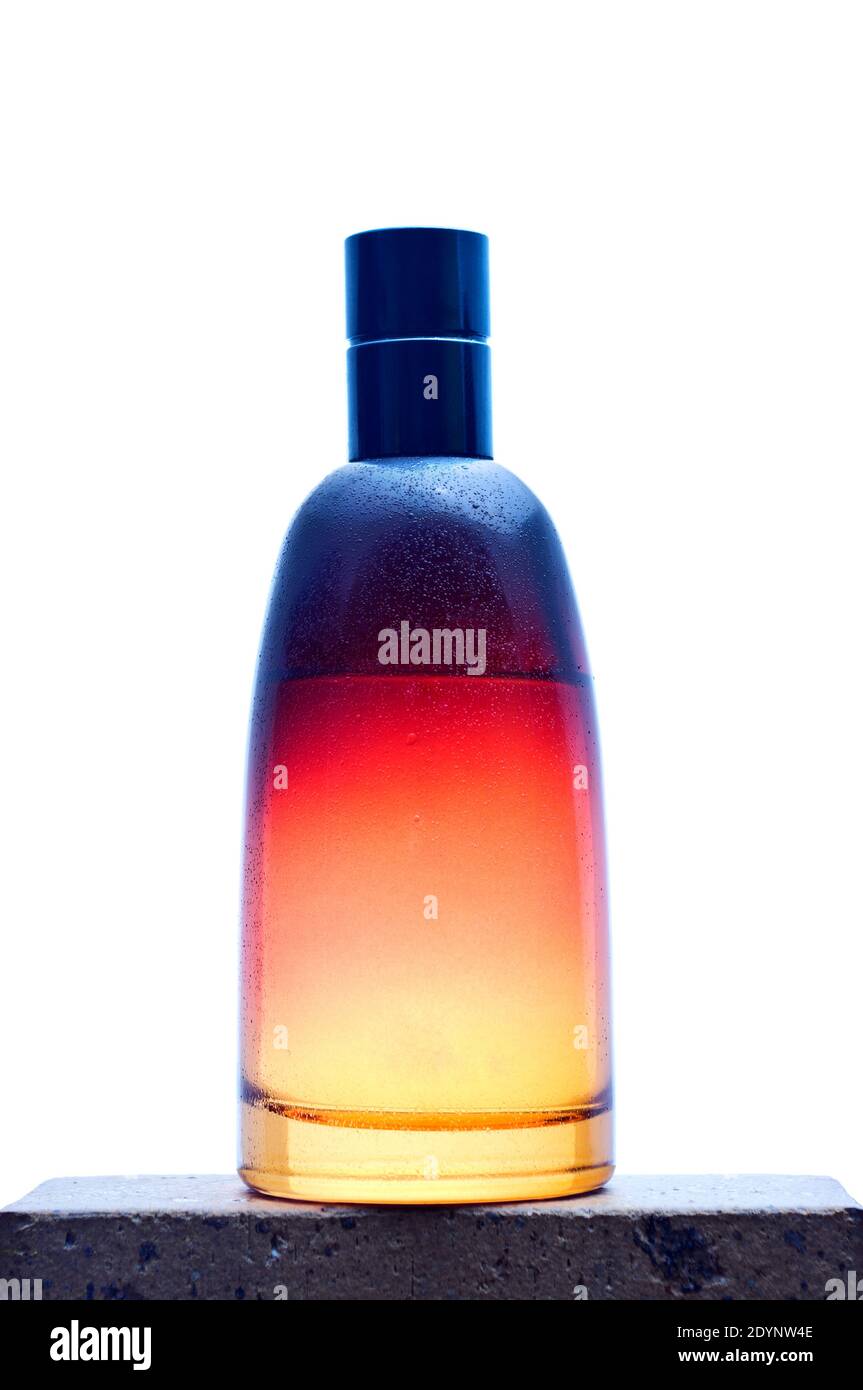 Orange glass bottle for perfume with diffuser on white background. Stock Photo