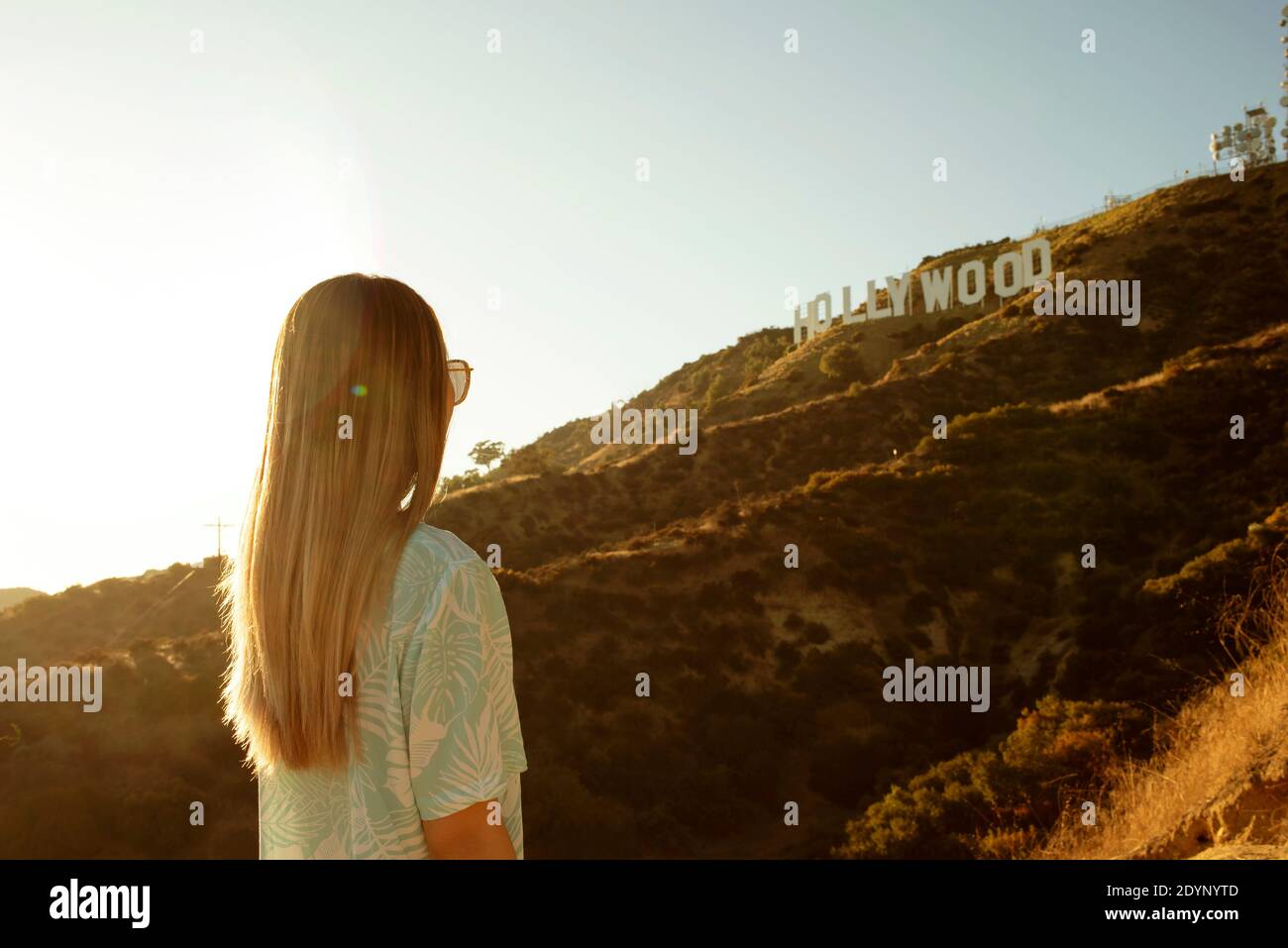Rear view of girl looking at The Hollywood Sign, Los Angeles, California, US. Aug 2019 Stock Photo