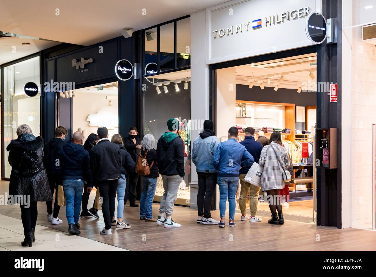 Valencia, Spain. 26th Dec, 2020. People a queue at the entrance of a Tommy Hilfiger in the Bonaire shopping center. Credit: SOPA Images Live News Stock Photo - Alamy