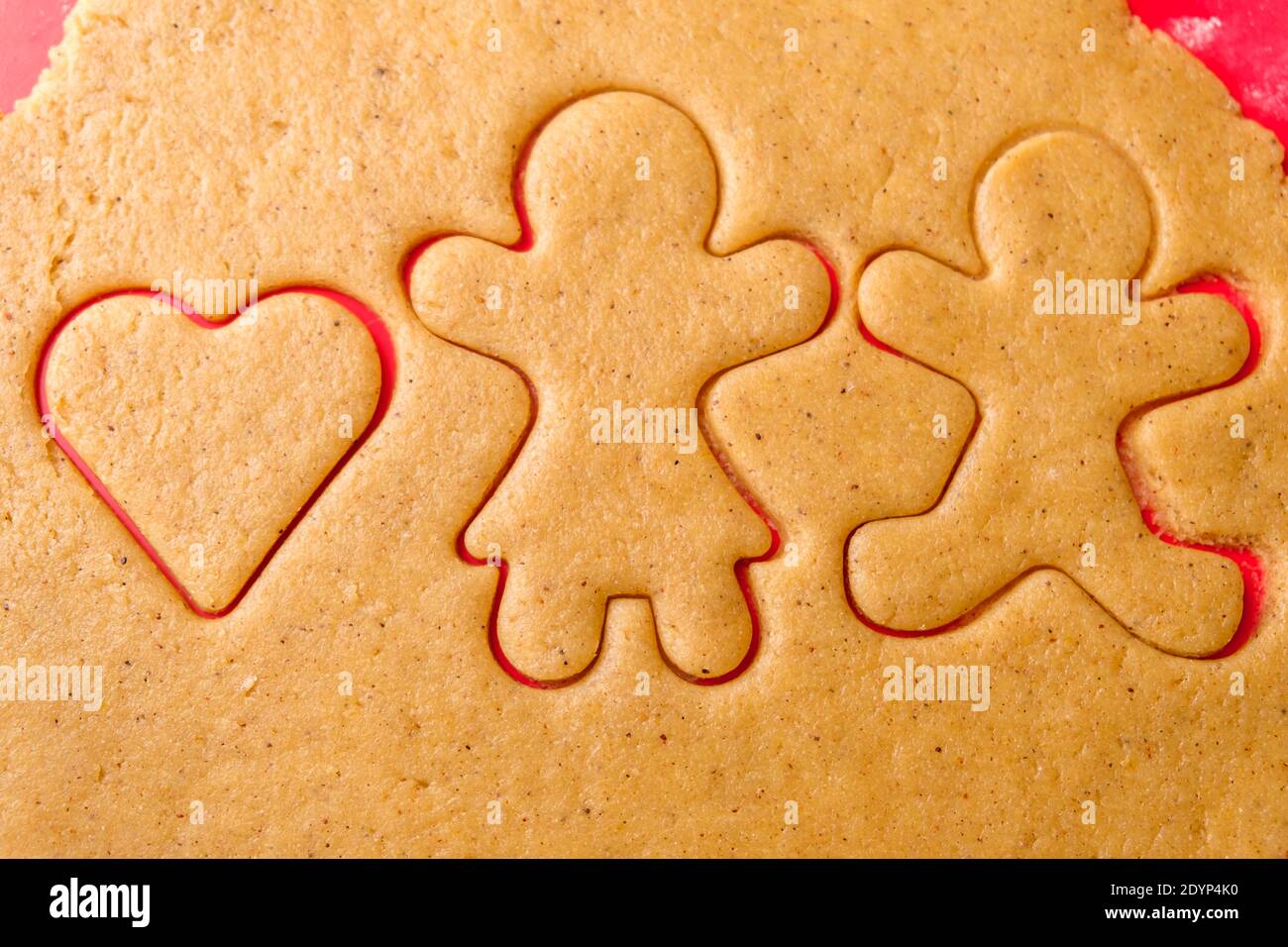 https://c8.alamy.com/comp/2DYP4K0/cutting-gingerbread-shapes-family-or-love-couple-concept-from-dough-for-st-valentines-day-2DYP4K0.jpg