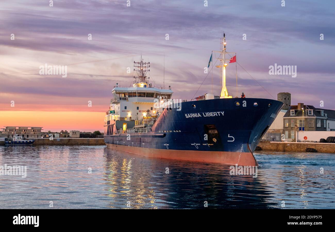 small cargo ship leaving harbour Stock Photo