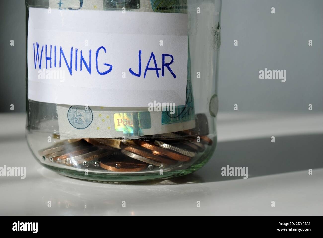 A close-up of a homemade 'whining jar' Every time you complain, you put a certain amount of money into it. Stock Photo