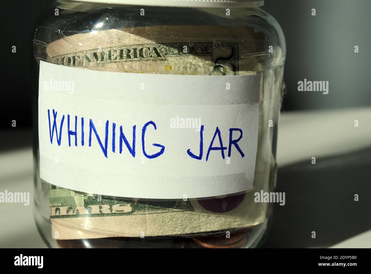 A close-up of a homemade 'whining jar' Every time you complain, you put a certain amount of money into it. Stock Photo