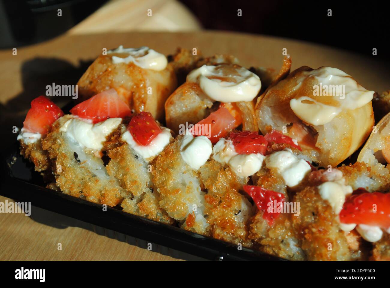 A display of freshly prepared fried sushi pieces ready to be enjoyed. Stock Photo