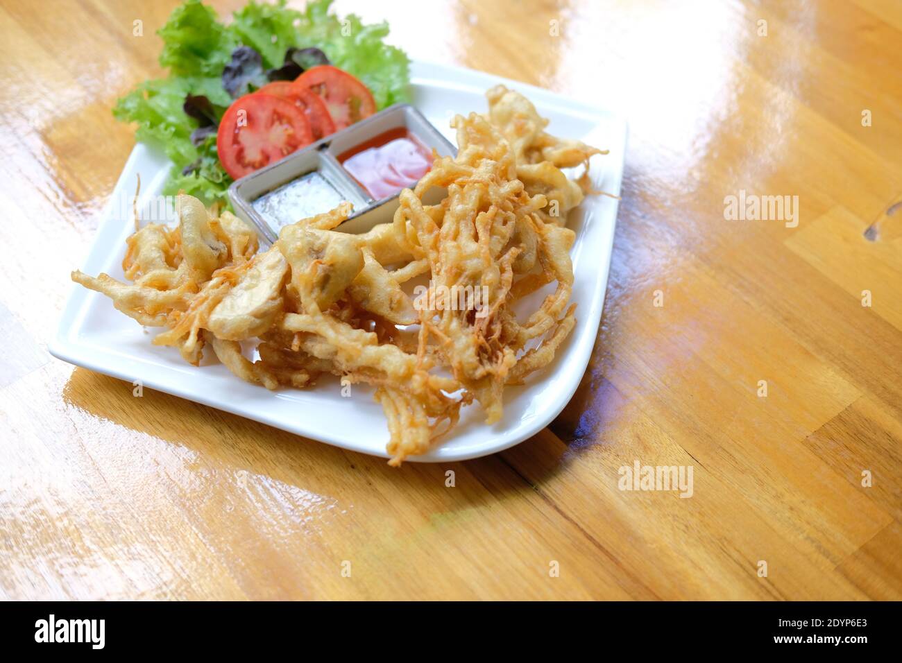 deep fried mushroom with dipping sauce and vegetable. vegetarian vegan