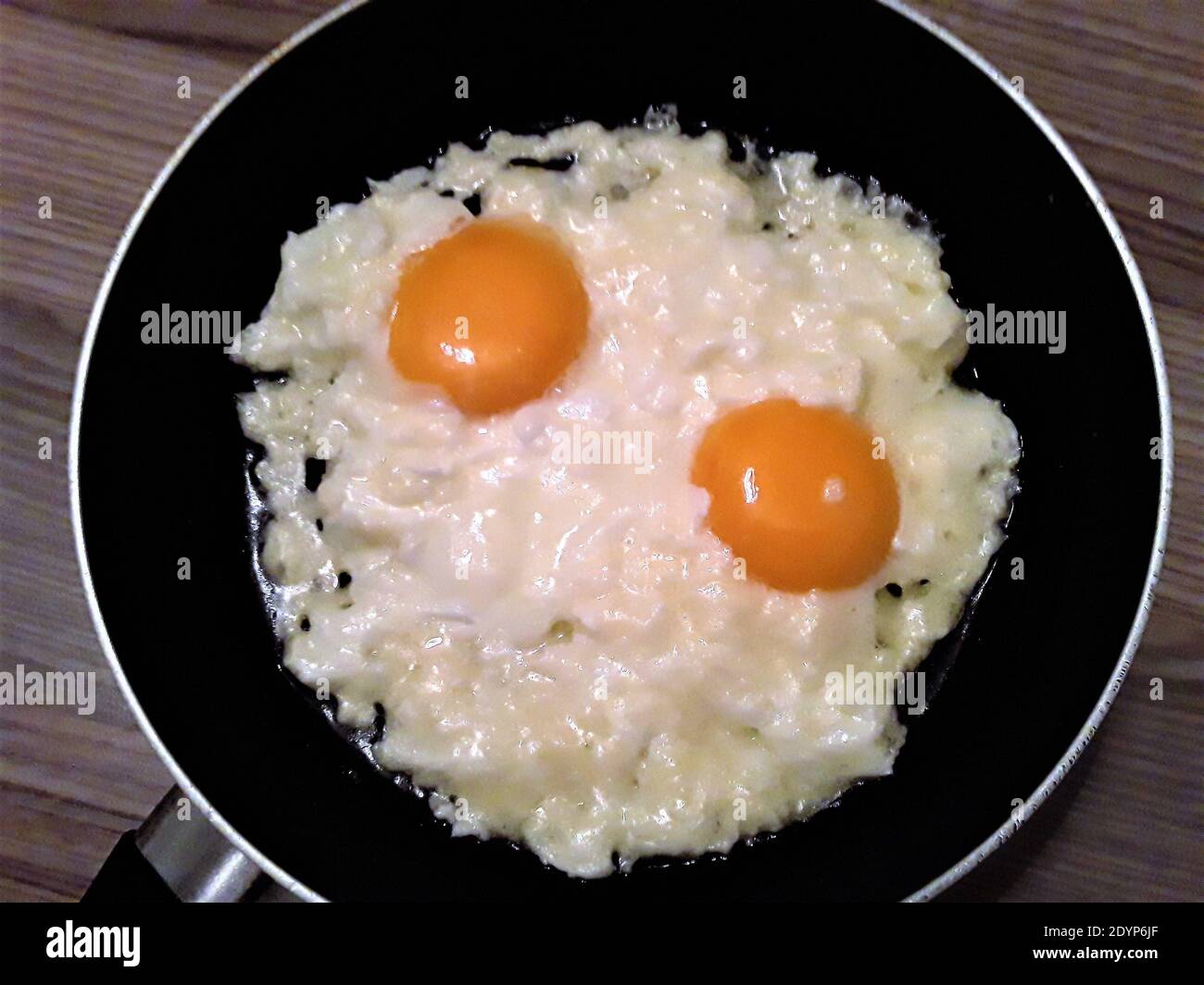 Two Eggs Undercooked In A Frying Pan Scrambled Eggs Stock Photo Alamy