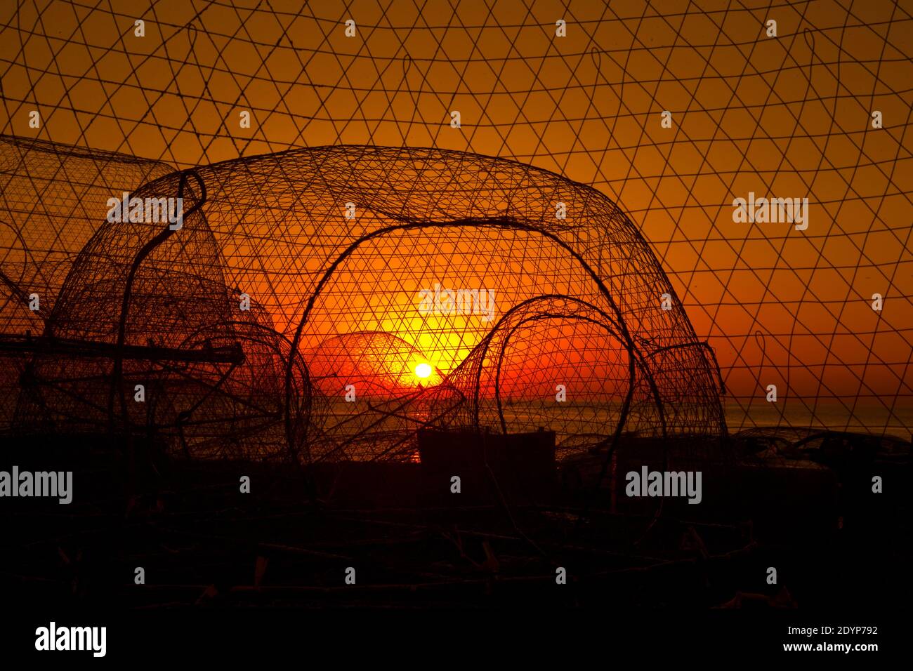 Fishing net with sunsets - QATAR Stock Photo