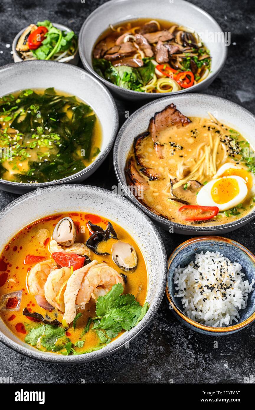 Assorted traditional Asian soups. Miso, Ramen, Tom Yam, Pho Bo. Black