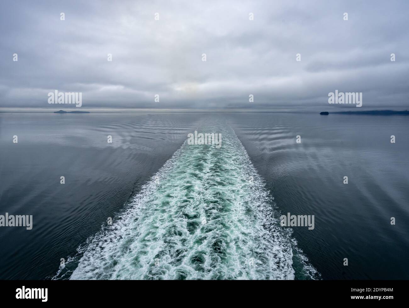 Wake behind a ship in deep water channel Stock Photo