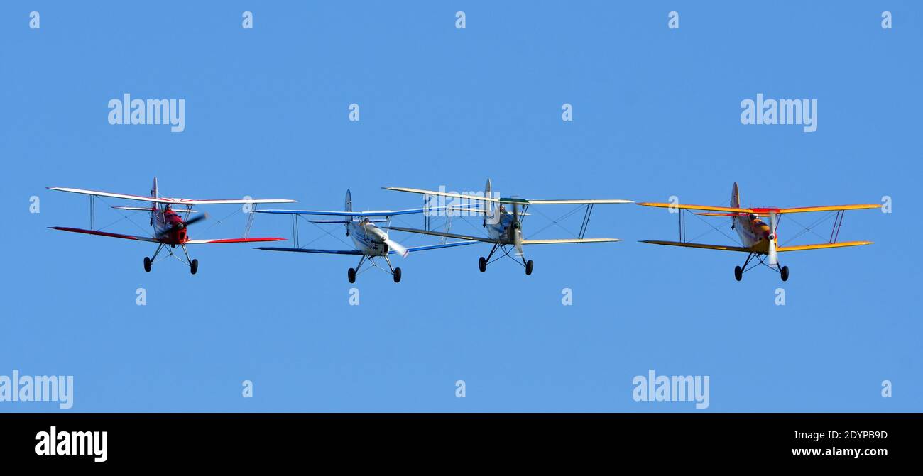 Four Vintage  SNCAN Stampe - Vertongen SV-4 Biplanes in flying formation. Stock Photo
