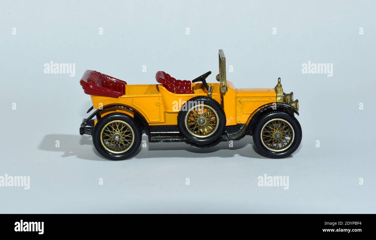 Toy diecast model of a Yellow 1911 Daimler a Matchbox yesteryear product by Lesney with white background Stock Photo