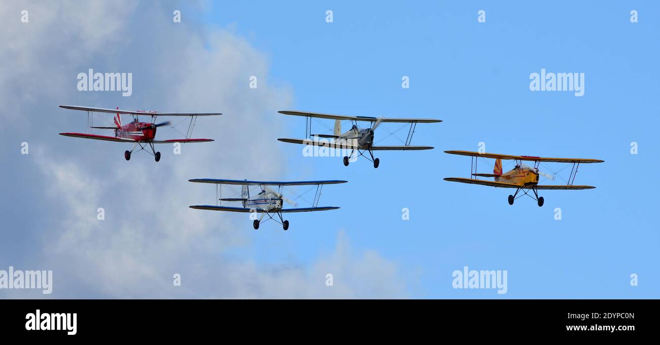 Four Vintage  SNCAN Stampe - Vertongen SV-4 Biplanes in flying formation Stock Photo