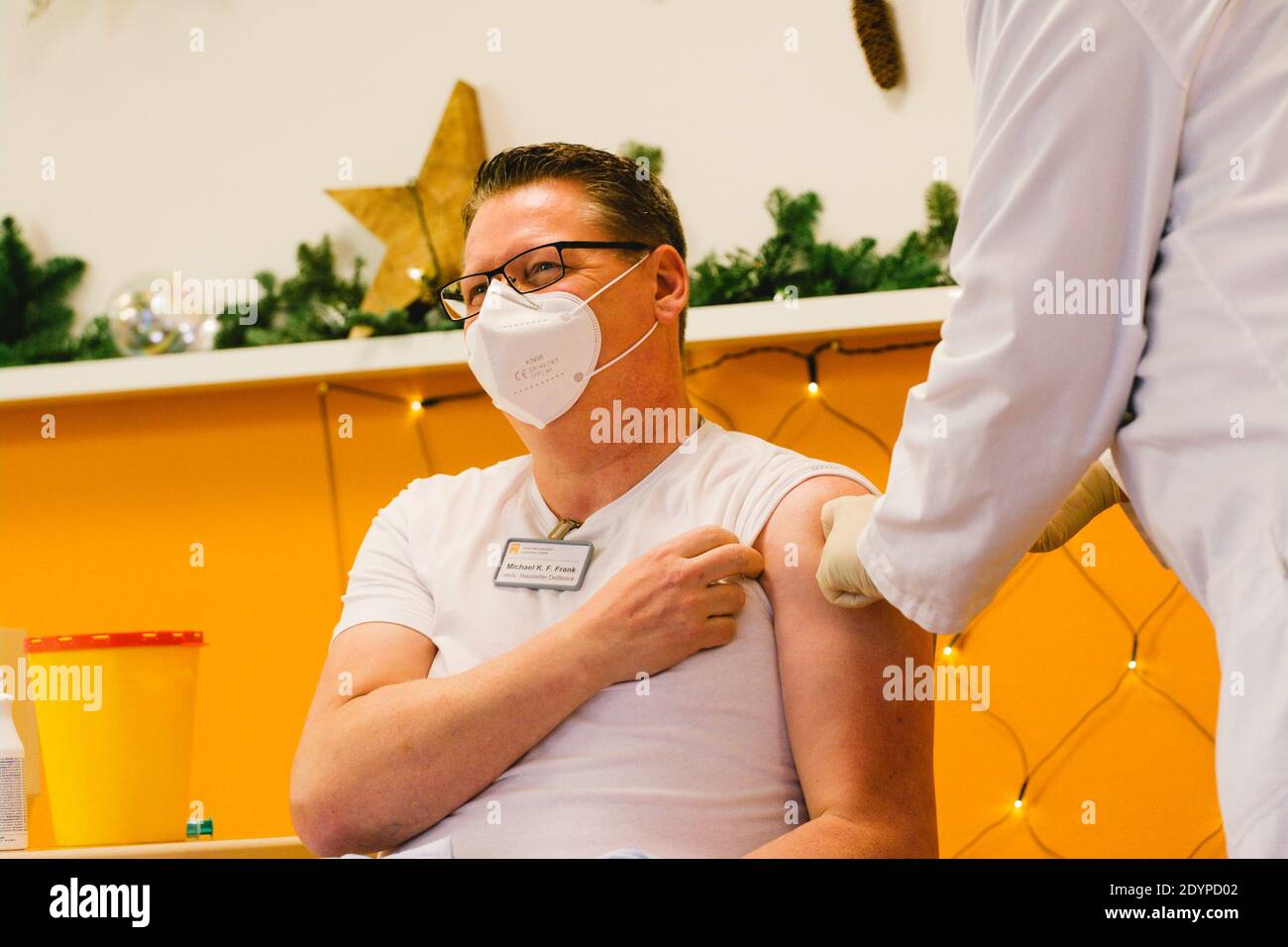 Cologne, Germany. 27th Dec, 2020. A nursing staff member receives an injection with a dose of COVID-19 vaccine at the Senior Centre Riehl in Cologne, Germany, Dec. 27, 2020. Credit: Tang Ying/Xinhua/Alamy Live News Stock Photo