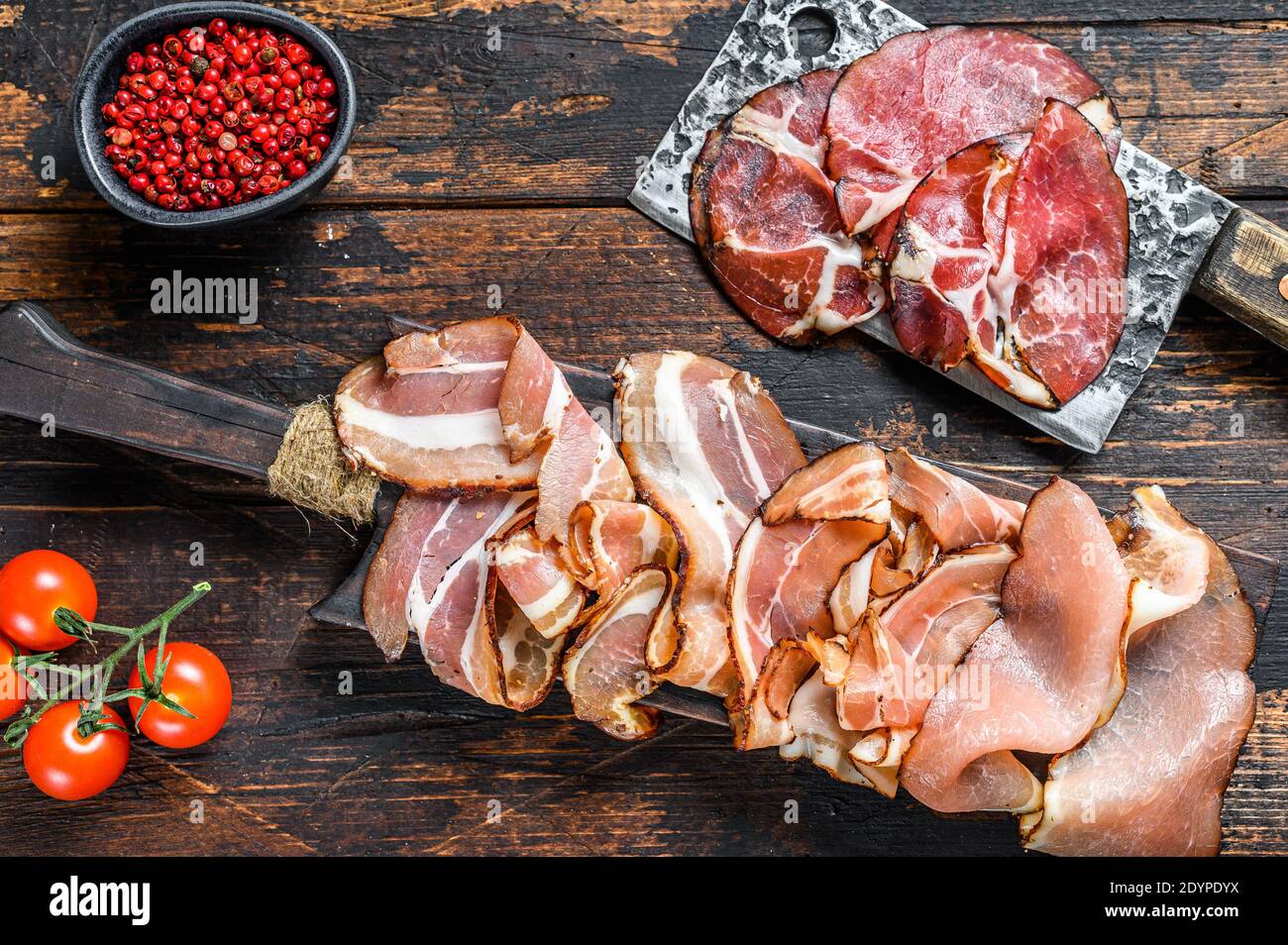 Set of cold cured italian meat Ham, prosciutto, pancetta, bacon. Dark