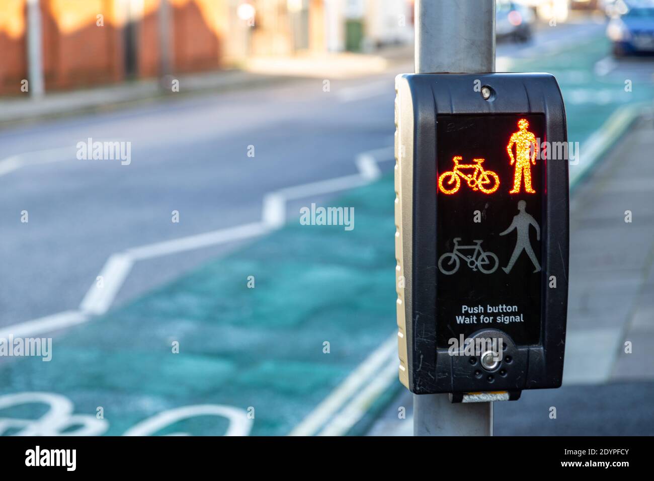 a pedestrian crossing button showing a red light to indicate do not cross Stock Photo