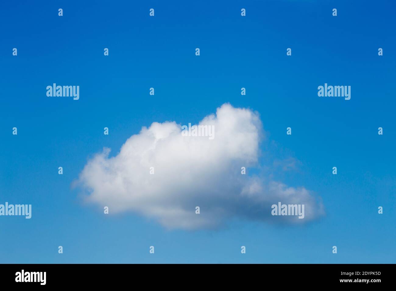 A white cloud with a blue sky in the background. Stock Photo