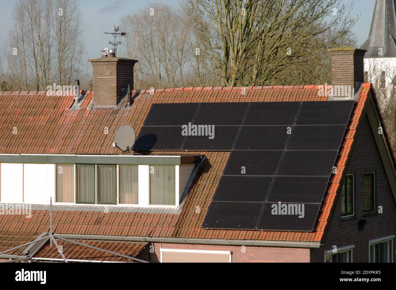 Solar panels on a red roof with dormer for electric power generation Stock Photo Alamy