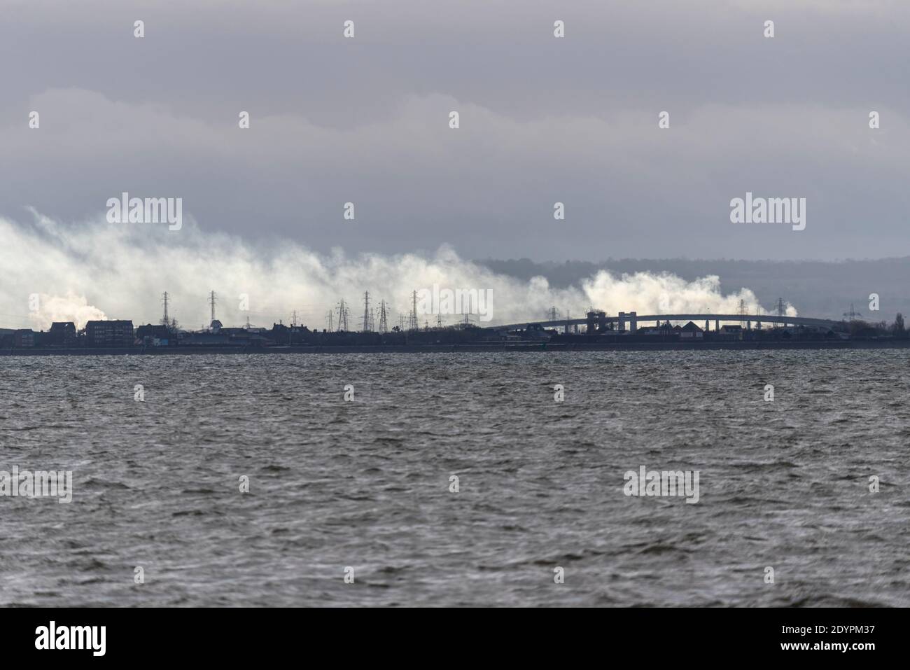 View from Southend on Sea, Essex, UK, across the Thames Estuary to Kent, with Sheppey Crossing, Sheerness and Minster visible. Power station steam Stock Photo