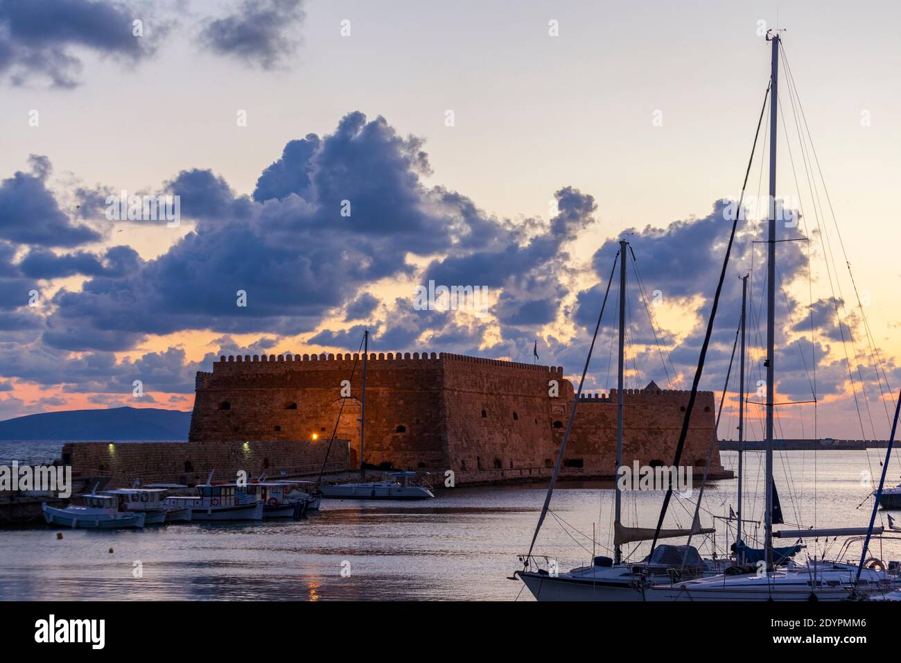 Sunrise at Heraklion old port, in Crete island, Greece, Europe. The fortress seen is Koules (Kules), the old venetian castle also known as Roca a Mare Stock Photo