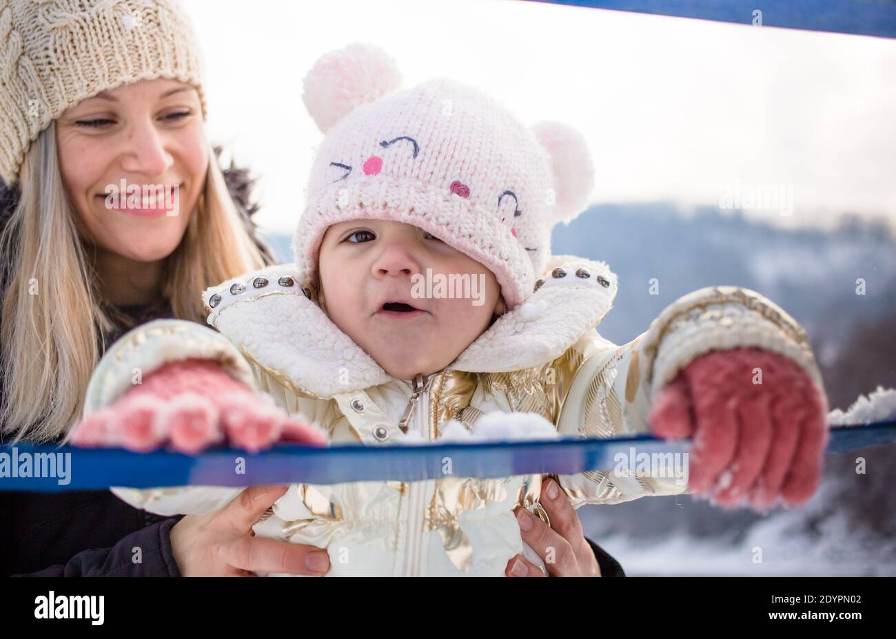 Happy family, mom with her daughter in winter clothing, winter time, outdoor activity Stock Photo