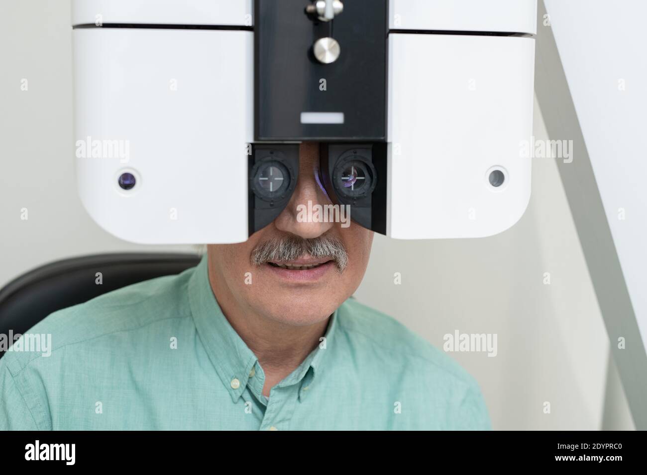 Face of senior male patient sitting in front of ophthalmological ...