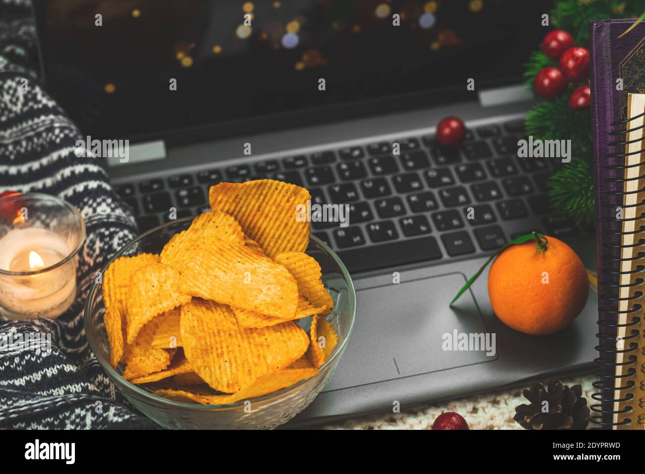 Cozy winter and autumn warm nights with movie watch and unhealthy food,  potato chips in bowl, knitted sweater close up Stock Photo - Alamy