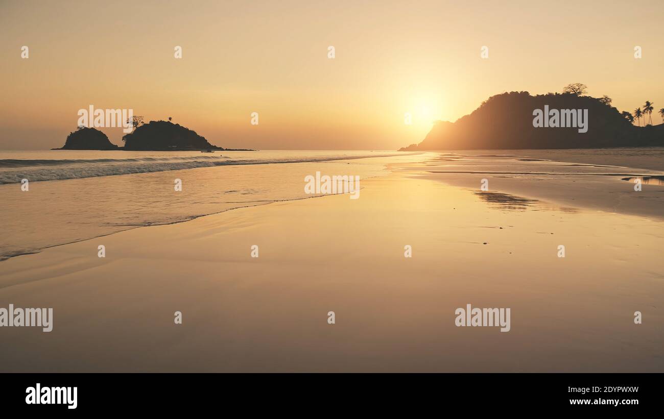 Silhouette of paradise mountains islands at sunset. Aerial sun set light reflection at seascape. Sea bay waves crash at sand beach. Sunny evening at Philippine, Asia. Nobody nature landscape Stock Photo