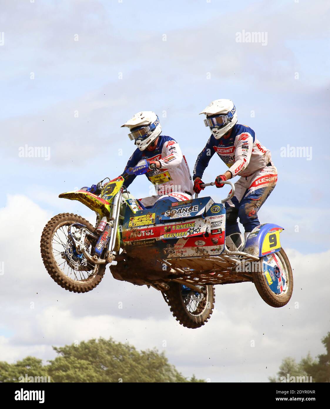 moto cross outfit with two riders flying through the air on a jump Stock  Photo - Alamy