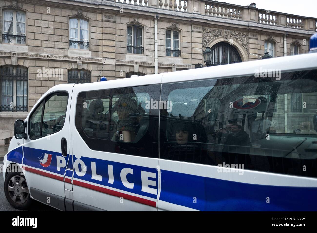 Police arrest Three FEMEN feminist activist protesting outside the presidential Elysee palace in Paris, France on July 3, 2013, calling for FEMEN activist Amina Sboui to be freed by Tunisian authorities. Sboui was arrested for painting the word 'Femen' on a wall near a cemetery in the central city of Kairouan in May, in protest against a planned gathering of radical Salafists, and risks prison terms of two years and six months respectively for desecrating a cemetery and indecency. French President Francois Hollande will start a two-day visit to Tunisia on July 4 to deliver a message of 'encour Stock Photo