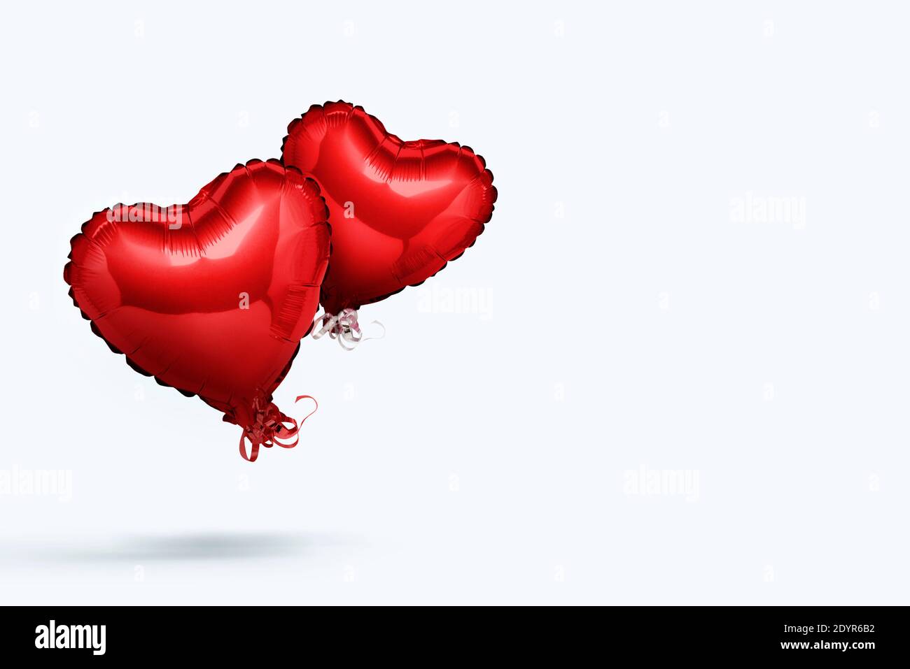 Pink air balloons heart shape on a white background. Concept wedding ...