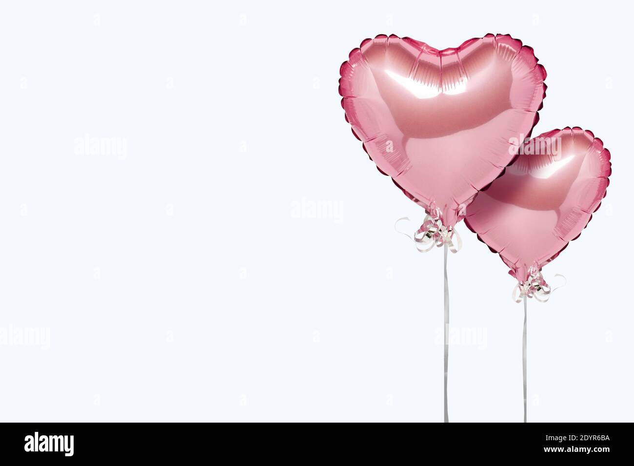 Pink air balloons heart shape on a white background. Concept wedding ...