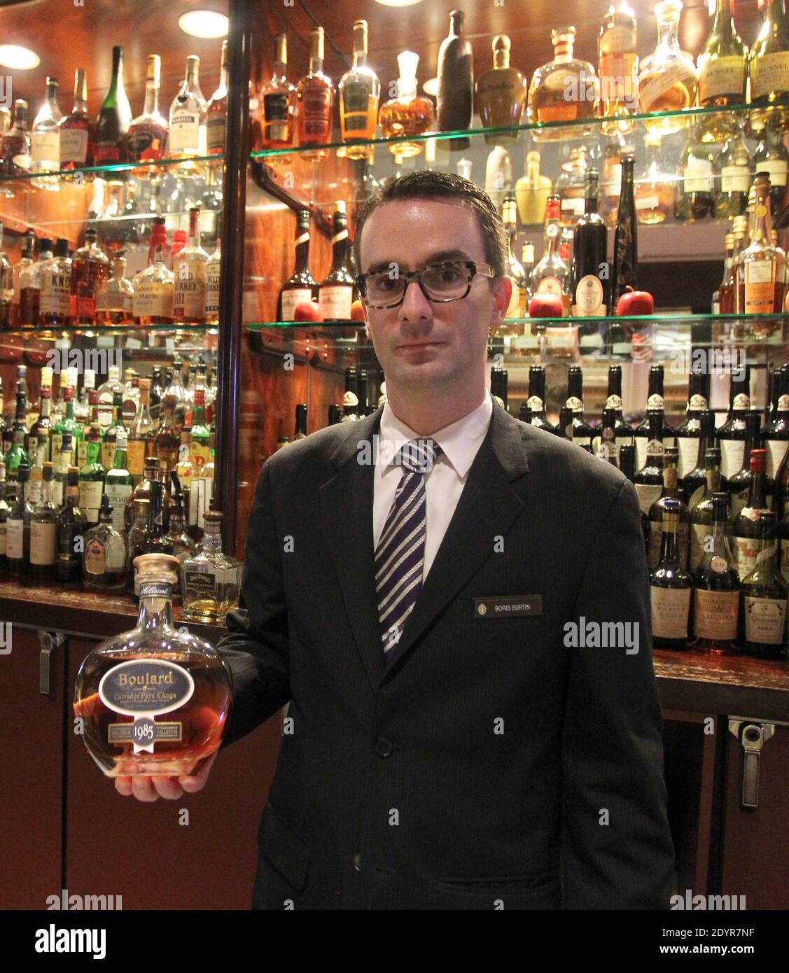 Boris Burtin, Restaurant and Bar manager with Jose Torrella Jr, Mixologist at the Barclay Bar at the Intercontinental in New York City, discusse the 30 types of the French apple brandy Calvados that the bar houses on July 5, 2013. Honored as the 'First Calvados Bar' in the US, the bar's menu offers a cocktail featuring calvados and apple juice from New York apples, 'flights' featuring four one-ounce tastings, and a 1939 vintage 'Apellation Calvados', priced at $198. A twice-distilled brandy from Normandy, Calvados blends over two dozen types of apples creating its distinct flavor and aroma. Ph Stock Photo