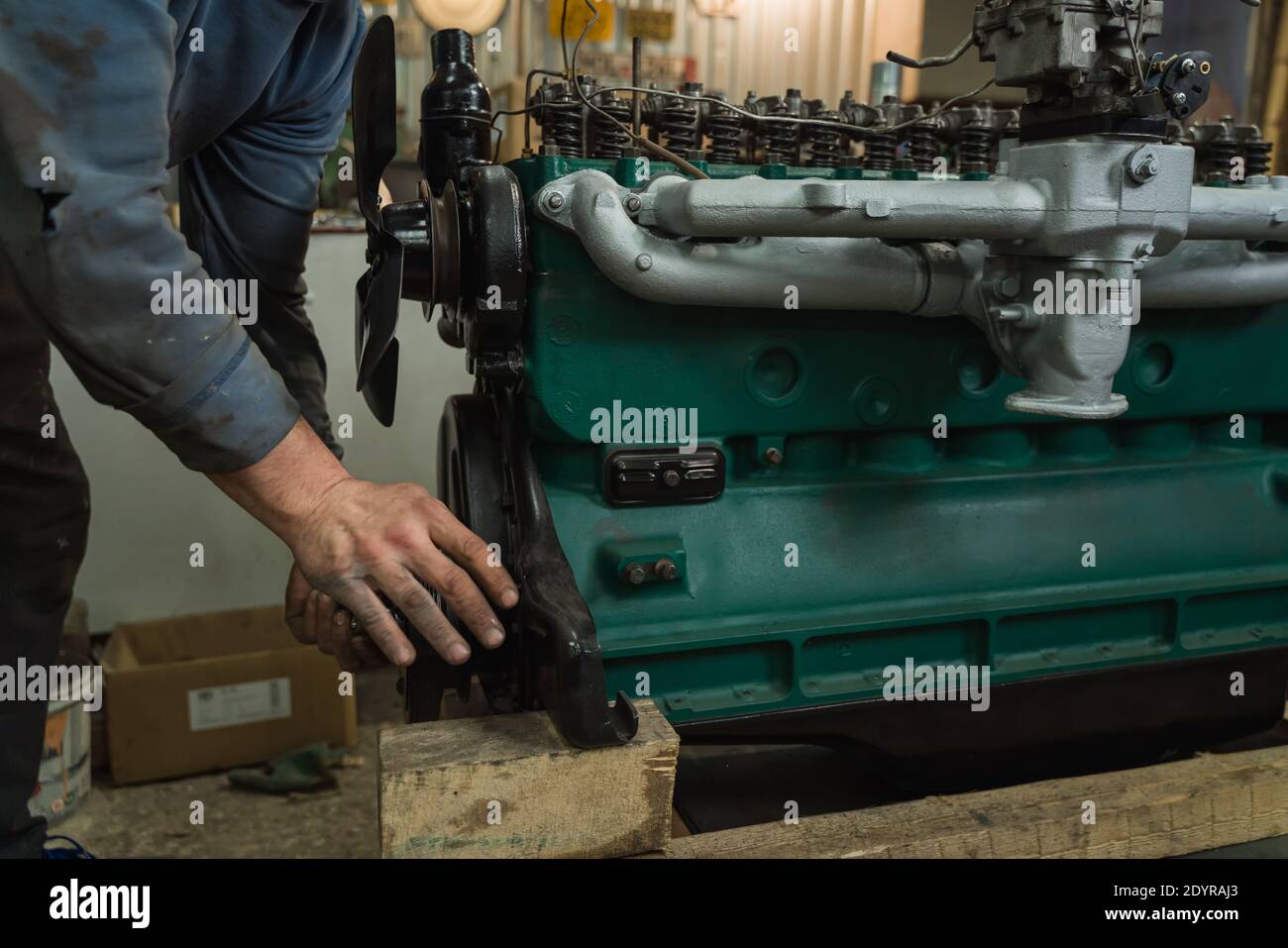 Car mechanic repairing an engine. Mechanic working on car engine