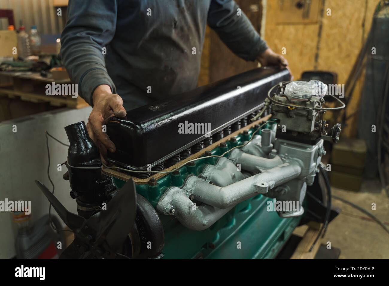 Car mechanic repairing an engine. Mechanic working on car engine. Mechanic workshop. Stock Photo