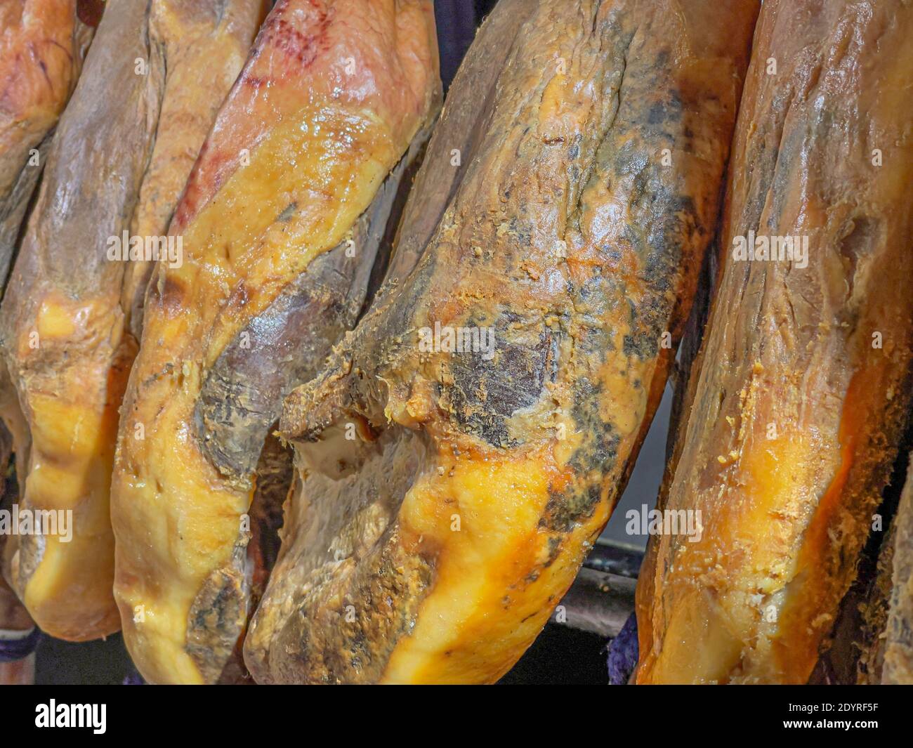 Whole legs of cured Spanish Iberian serrano ham (Jamon Serrano) hanging